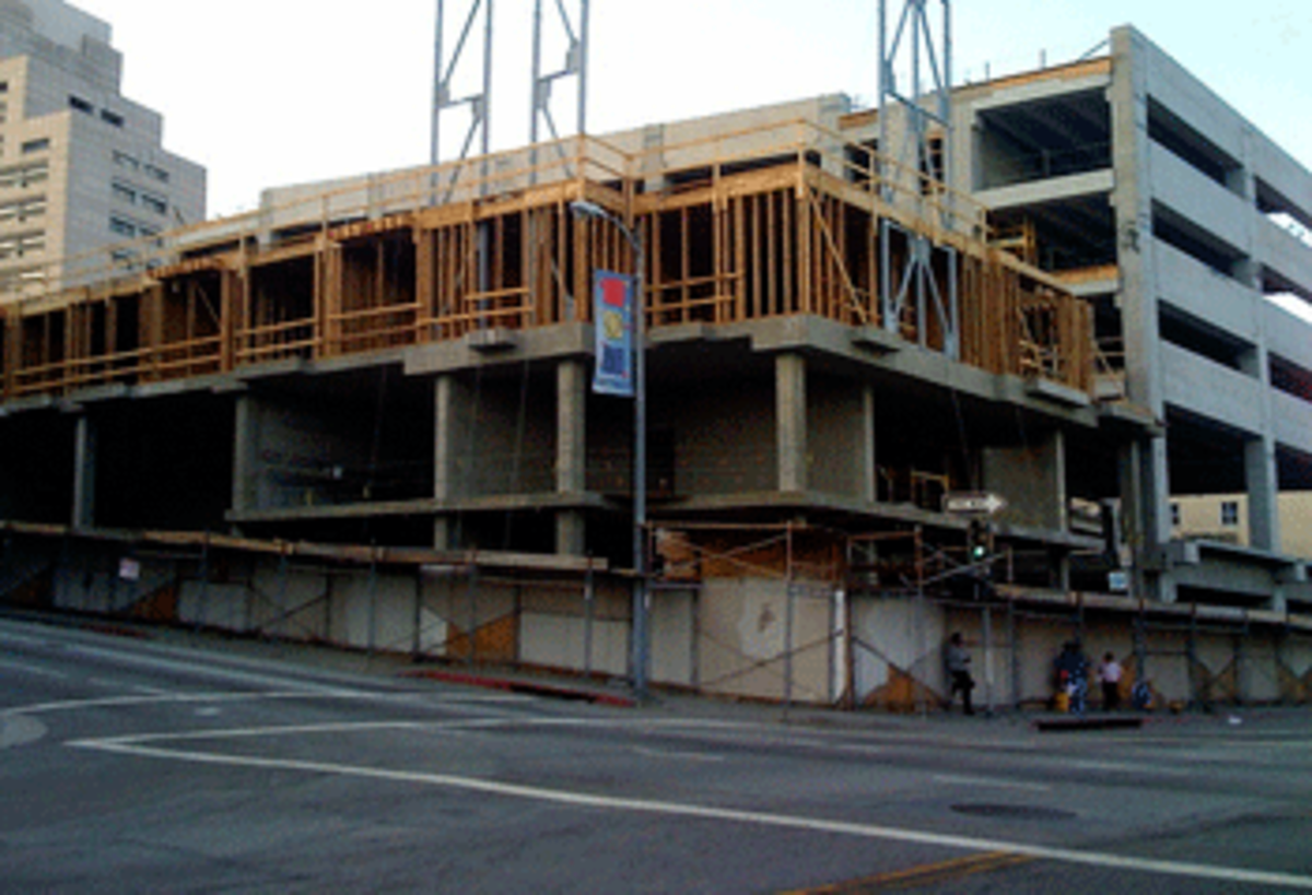 New construction in downtown L.A. Homeless people right below it. (Photo by Linda Milazzo)