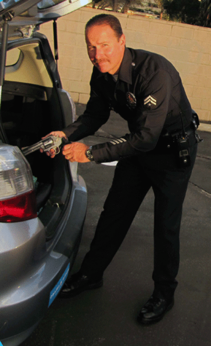 Officer Removing Gun from M I Gave Up My Firearm Today