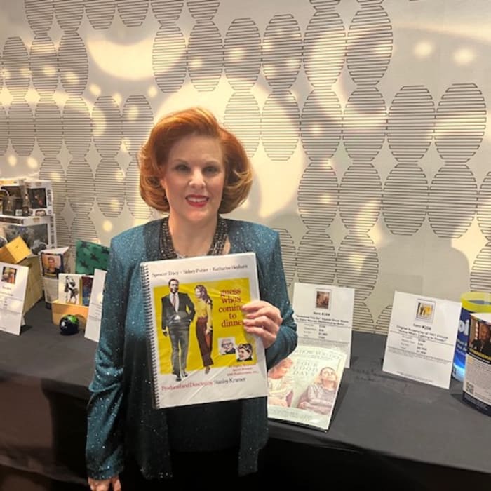 Kat Kramer holding the silent auction item she curated/donated to the HRC 2022 Dinner. A "Grace and Frankie" Season 7 script, signed by Jane Fonda and Lily Tomlin.
