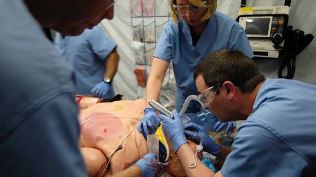 (left to right) Capt. Jeremy Egly, Staff Sgt. Rebecca Timms and Maj. David Olson work on a human patient simulator during a training simulation at the Center for Sustainment of Trauma and Readiness Skills (C-STARS), St. Louis University Hospital, July 5, 2007.  C-STARS is a training program created for Air Force medical personnel that is integrated into major civilian trauma centers throughout the continental United States. The integration with civilian counter parts provides real-life hands on trauma care experience to Air Force medical personnel. (U.S. Air Force photo/Staff Sgt. Brian Ferguson)