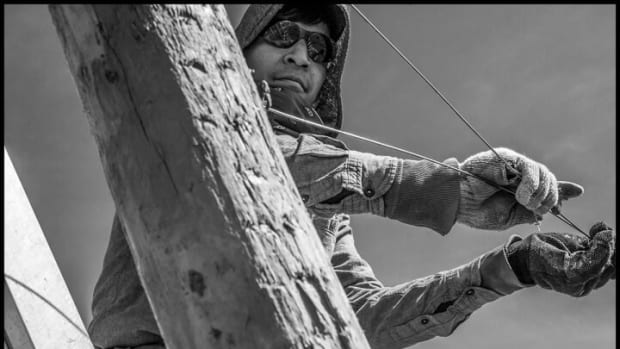 ROYAL CITY, WA- Carlos Gutierrez, an immigrant H-2A guest worker, strings up wire supports for planting apple trees in a Stemilt Company field.