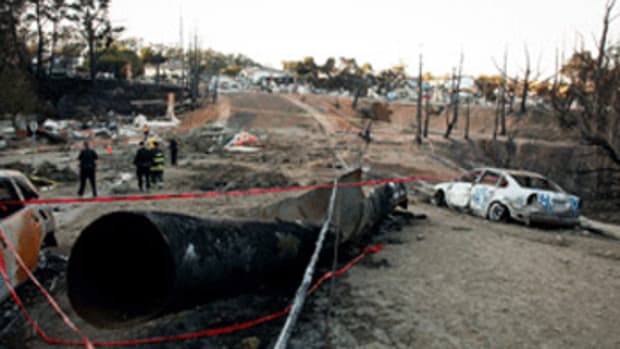The remains of a gas line lie on the ground after an explosion September 10, 2010 in San Bruno, California. (Photo by Eric Risberg-Pool/Getty Images)