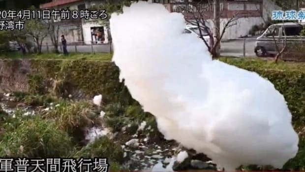 Carcinogenic foam from Marine Corps Air Station Futenma floats above Ginowan City, Okinawa on April 10, 2020.