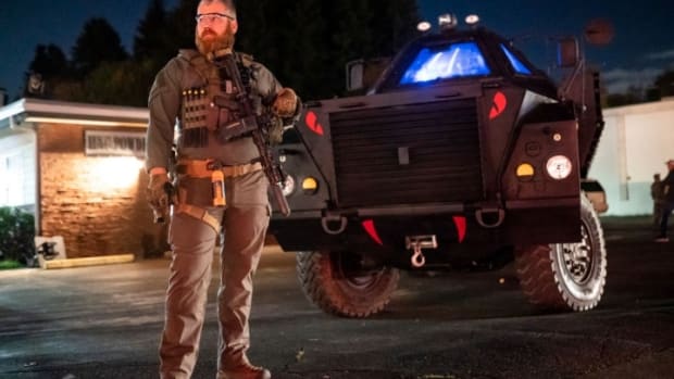 VANCOUVER, WA - OCTOBER 30: A right-wing militia member guards a business with an armored vehicle during a vigil for Kevin E. Peterson Jr., on October 30, 2020 in Vancouver, Washington. Clark County Sheriffs deputies shot and killed Peterson, 21, Thursday night, sparking city-wide dueling protests between Black Lives Matter activists and supporters of President Donald Trump. (Photo by Nathan Howard/Getty Images)