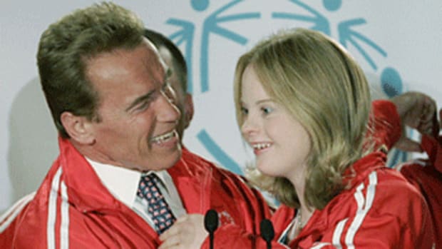 Schwarzenegger hugs Team Canada Special Olympics gymnast Emily Boycott [Reuters