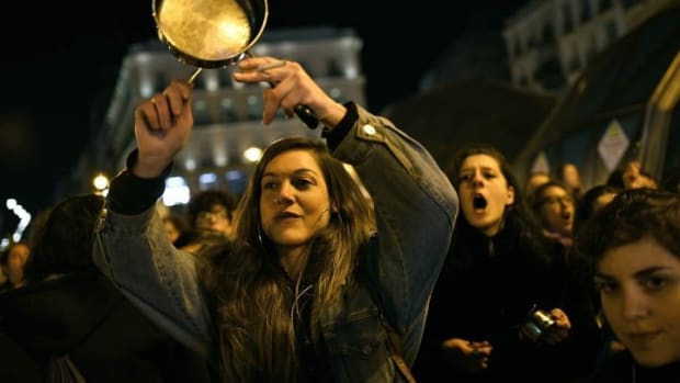 Spanish women bang pots and pans, shouting angry slogans during the 'cacerolada' (a pot-banging protest) at the Sol Square in Madrid. JUAN CARLOS LUCAS/NURPHOTO/GETTY