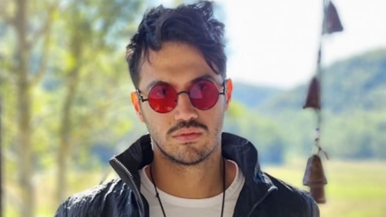 Who is the famous Iranian songwriter Amir Nasir?