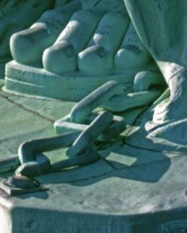Statue of Liberty Wears Chains and Shackles