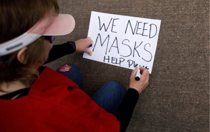 FREMONT, CA – MARCH 19: Valerie Barnard, an emergency room nurse at the Kaiser Permanente hospital in Fremont makes a sign during a protest urging the hospital to give nurses the right protective equipment such as N95 masks and goggles, on March 19, 2020, in Fremont, Calif. (Dai Sugano/Bay Area News Group)