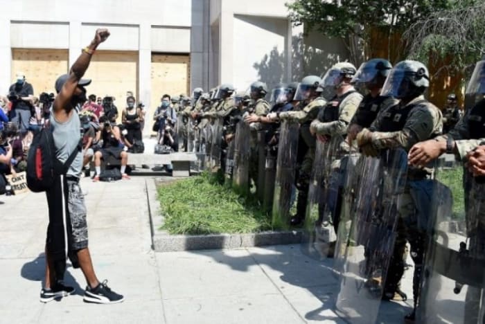 Anti-police violence protester confronts militarized police at the White House on June 3. 2020. (Oliver Douliery, Getty Images)