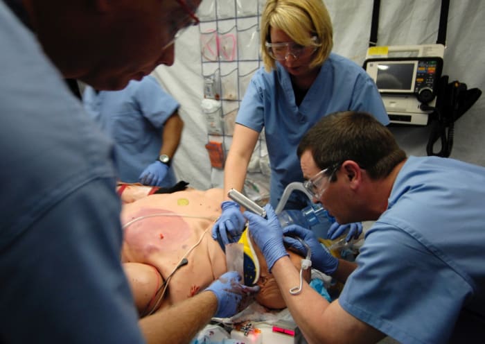 (left to right) Capt. Jeremy Egly, Staff Sgt. Rebecca Timms and Maj. David Olson work on a human patient simulator during a training simulation at the Center for Sustainment of Trauma and Readiness Skills (C-STARS), St. Louis University Hospital, July 5, 2007. C-STARS is a training program created for Air Force medical personnel that is integrated into major civilian trauma centers throughout the continental United States. The integration with civilian counter parts provides real-life hands on trauma care experience to Air Force medical personnel. (U.S. Air Force photo/Staff Sgt. Brian Ferguson)