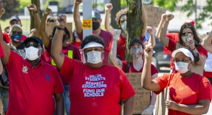 Detroit teachers rallied against police brutality on June 7 outside the headquarters of the city's police department. Some teachers unions are demanding that resources be redistributed from police to schools. Photo: Jim West, jimwestphoto.com.