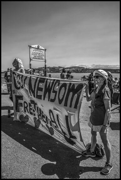 The vigil called on Governor Gavin Newsom to release prisoners from San Quentin, and some held a banner saying "Release Them All!" Many speakers denounced what they called a "virtual death sentence" imposed on prisoners because of the COVID contagion.
