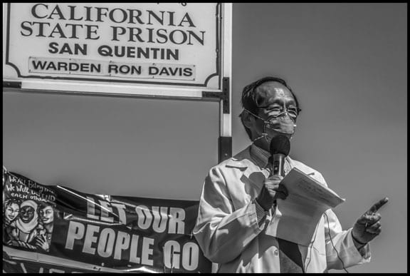 Dr. Art Chen, a doctor at Asian Health Services in Oakland, tells vigil participants, "There is no "safe" way to social distance in overcrowded prisons, operating well above 100% capacity. There is no safe way to transfer incarcerated folks from one prison to another without risking a new hot spot." He asked Governor Newsom, "How many more incarcerated folks will face death during this pandemic before you begin mass releases?"