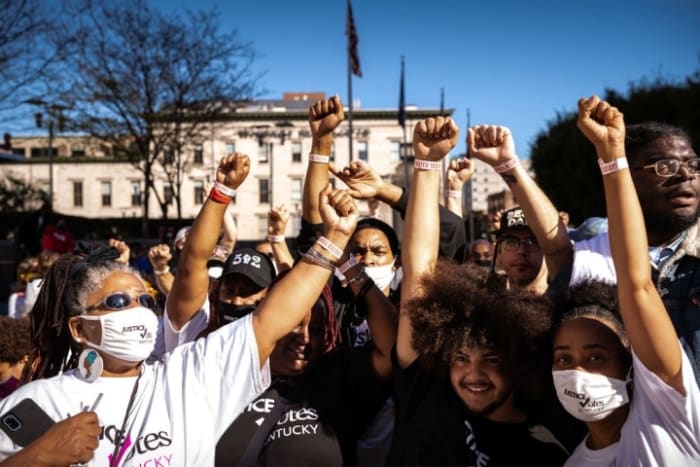Black Lives Matter protesters display their I VOTED wristbands in Louisville, Kentucky. (Photo by Jon Cherry/Getty Images)