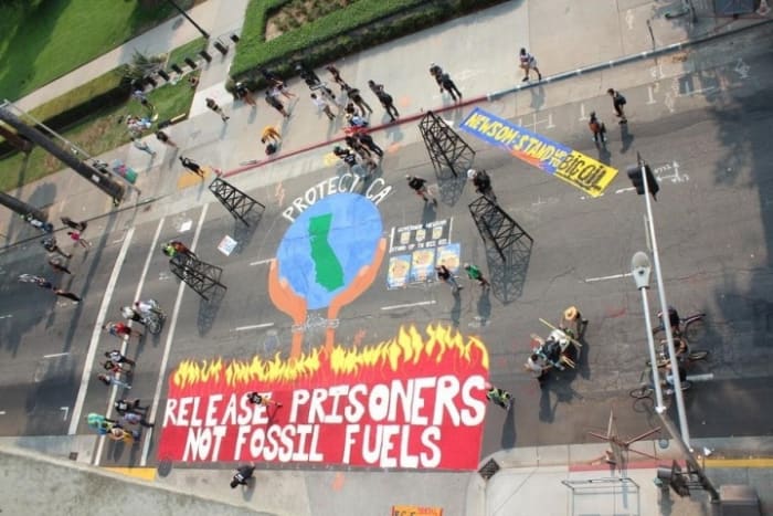 Climate justice activists painted a big mural on L Street in front of the State Capitol on Sunday, September 20, Photo by Dan Bacher.