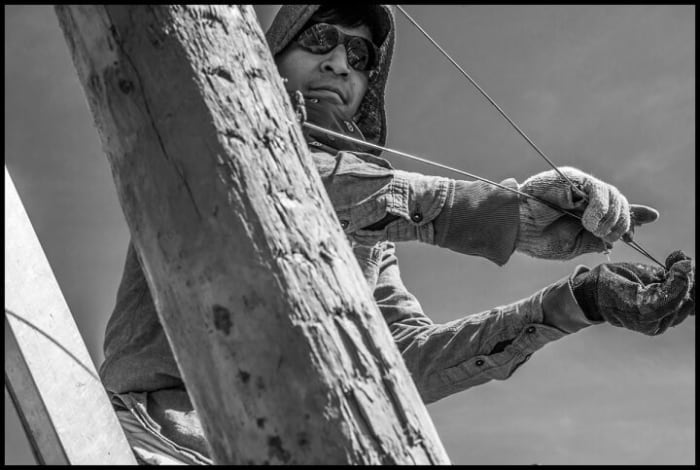 ROYAL CITY, WA- Carlos Gutierrez, an immigrant H-2A guest worker, strings up wire supports for planting apple trees in a Stemilt Company field.