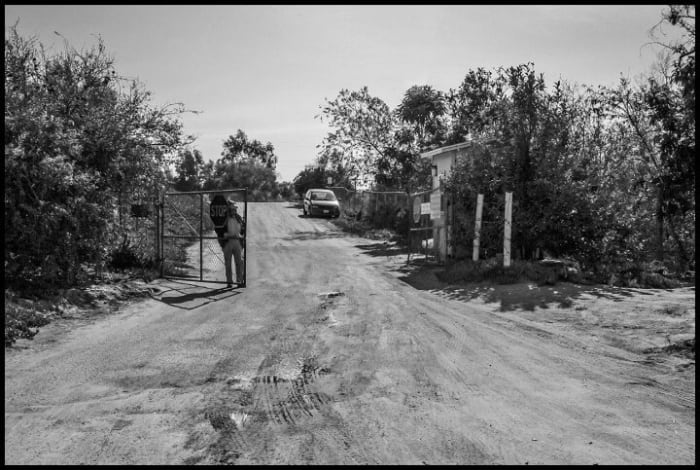 CAMP PENDLETON, CA – Behind this gate H2-A guest workers working for grower Harry Singh sleep in a labor camp on Singh’s ranch, keeping them isolated from the surrounding community. Guest workers can’t leave their jobs without being deported.