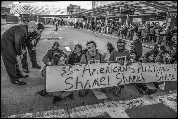 SAN FRANCISCO, CA - 14FEBRUARY2020 - Workers who prepare food for airlines and their supporters demonstrate at San Francisco International Airport, protesting the failure of employers to agree on a fair contract. Workers, members of UNITE HERE Local 2, were protesting low wages that force many workers to work an additional job besides their job in the airline food kitchens. Workers did a die-in, laying down inside the terminal, and then blocked the roadway outside. 31 workers and supporters were arrested.Copyright David Bacon