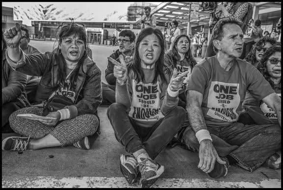 SAN FRANCISCO, CA - 14FEBRUARY2020 - Workers who prepare food for airlines and their supporters demonstrate at San Francisco International Airport, protesting the failure of employers to agree on a fair contract. Workers, members of UNITE HERE Local 2, were protesting low wages that force many workers to work an additional job besides their job in the airline food kitchens. Workers did a die-in, laying down inside the terminal, and then blocked the roadway outside. 31 workers and supporters were arrested.Copyright David Bacon