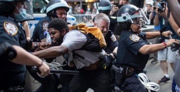 Police detain protesters as they march down the street during a solidarity rally for George Floyd, Saturday, May 30, 2020, in New York. AP Photo/Wong Maye-E.