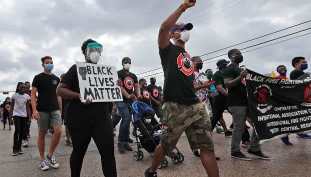 Protesters march in a Black Lives Matter demonstration organized by the Dallas Black Firefighters Association on Juneteenth 2020 in Dallas. AP Photo/LM Otero.