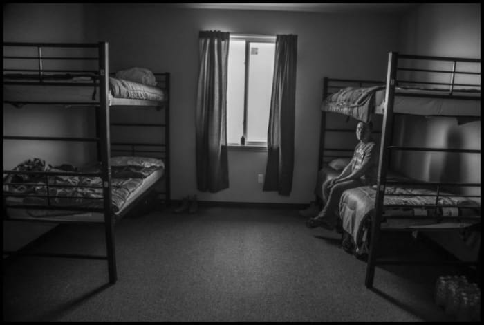 H2A contract worker B. Mendoza Vasquez in the room he shares with three other workers in the barracks where they live in central Washington state.