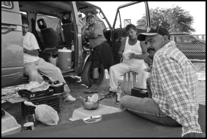 Enrique Saldivar, Leoncio Mendoza and Alfonso Leal come from Mexicali, on the U.S. border 100 miles to the south, to pick grapes every year. At the height of the harvest they eat and sleep next to their car in the parking lot of a market in Mecca.