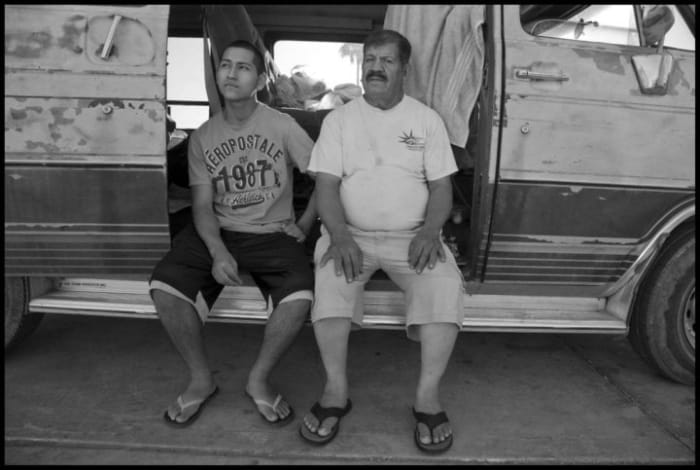 Rafael and Ricardo Lopez pick grapes in California’s Coachella Valley. They come from San Luis, Arizona, and live in their van in a parking lot in Mecca during the harvest.
