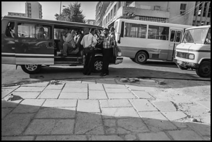 In Baghdad people depend for transportation on a network of crowded vans, which make it difficult to maintain social distancing. The curfew now makes travel like this virtually impossible. Copyright David Bacon