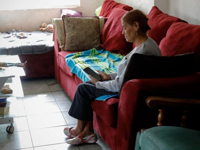 Ana Arellano sits in her living room waiting for her son, Jose Arellano, to call from the federal Adelanto Detention Center in California. Photo by Zaydee Sanchez