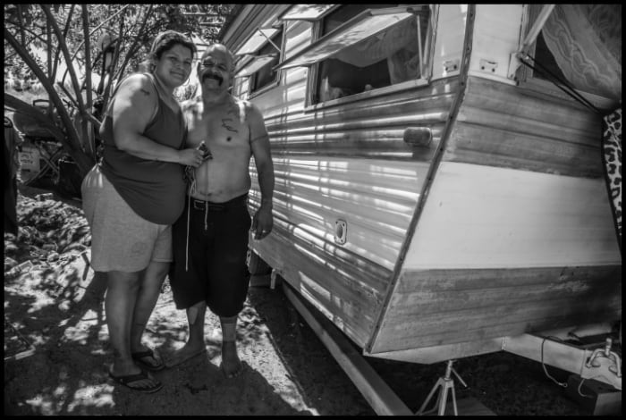 POPLAR, CA - 12JULY20 - Rosendo and Josefina live in a trailer in an encampment on the Tule River levee near Porterville. Rosendo was released from prison just eight months earlier, after being incarcerated for 38 years. The moved the trailer to the levee because they have no money to pay rent. Copyright David Bacon