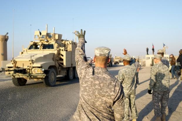 In December 2011, US soldiers wave at their comrades as they cross the border between Iraq and Kuwait on the last US military convoy carrying troops from Iraq marking the end of the presence of US army in Iraq (AFP)