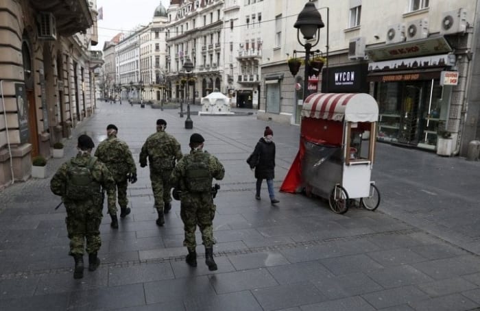 Serbian army soldiers patrol in Belgrade's main pedestrian street, in Serbia. (AP Photo/Darko Vojinovic)