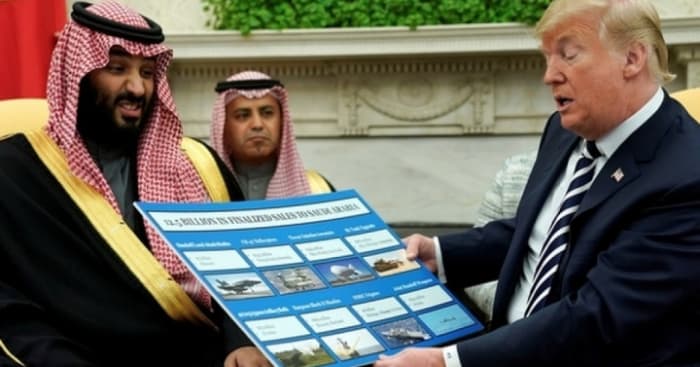 Trump holds a chart of weapon sales as he welcomes Mohammed bin Salman in the Oval Office, March 20, 2018. (Photo: Reuters)