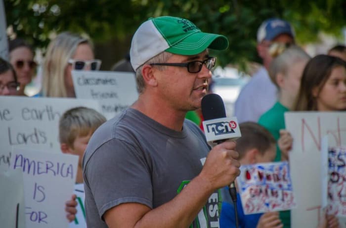 Corkle speaks at a rally in support of affected families in O’Neill on the lawn of the county courthouse the day of the raids.