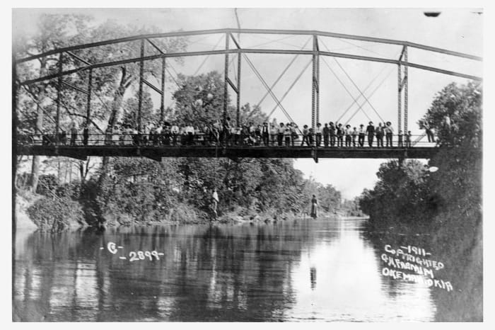 Laura Nelson and her son, L.D., were lynched by a white mob in Oklahoma in 1911. George Henry Farnum, the owner of Okemah’s only photography studio, took photographs, which were distributed as postcards. (Source: Wikimedia Commons)