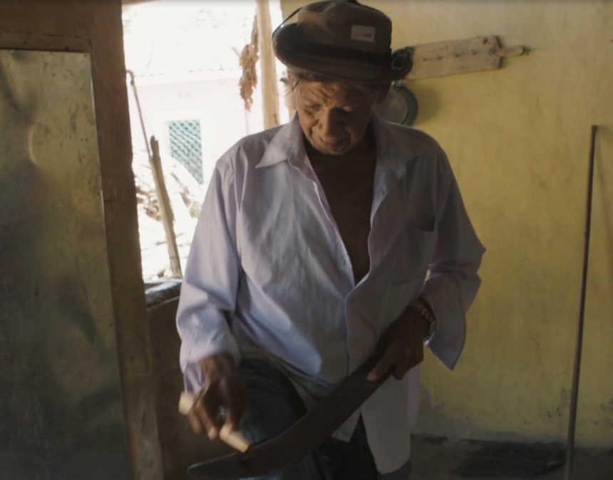 Don Pedro gets ready for a day of work on his farm in Honduras. Don Pedro’s son, Darwin, died while on the long migration trail to the United States. He’d hoped to earn money to help support a family farm crippled by drought. Photo courtesy of Armando Guerra and Gerry Hadden