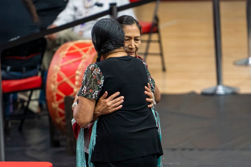 Delores Twohatchet, who is Kiowa and Comanche, gives Secretary Haaland a shawl as a gift. Nick Oxford for The Imprint