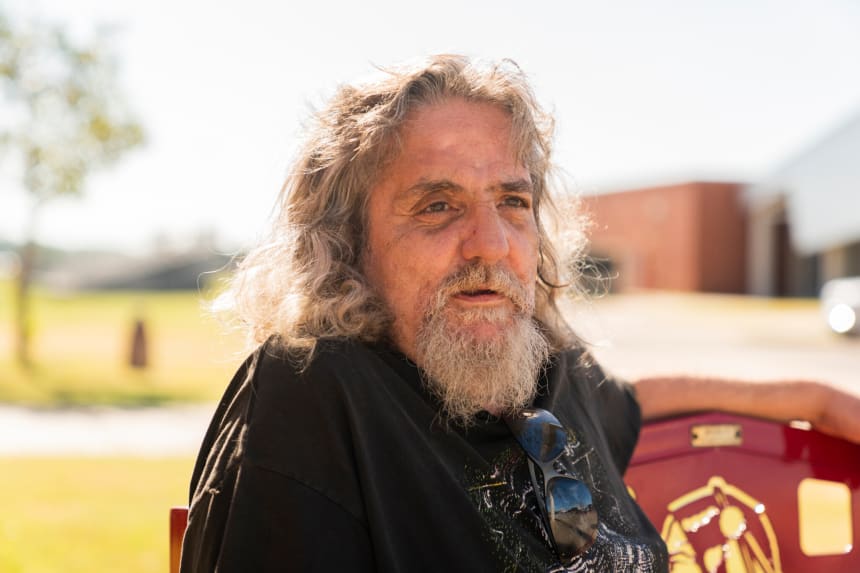 Bruce Charles Lachniet sits on a bench outside Riverside Indian School during the Road to Healing event. Nick Oxford for The Imprint