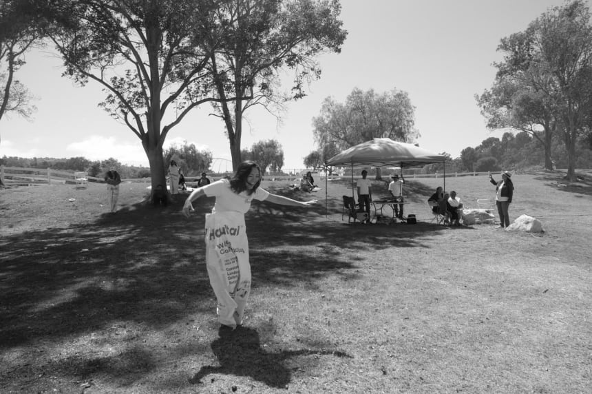 Debbie participates in a sack race game during a pre-Fourth of July church service. The church tries to keep Sunday worship as entertaining as possible for the youth by holding service in a park and providing fun activities. July 3, 2022. Photo by Zaydee Sanchez for Palabra.