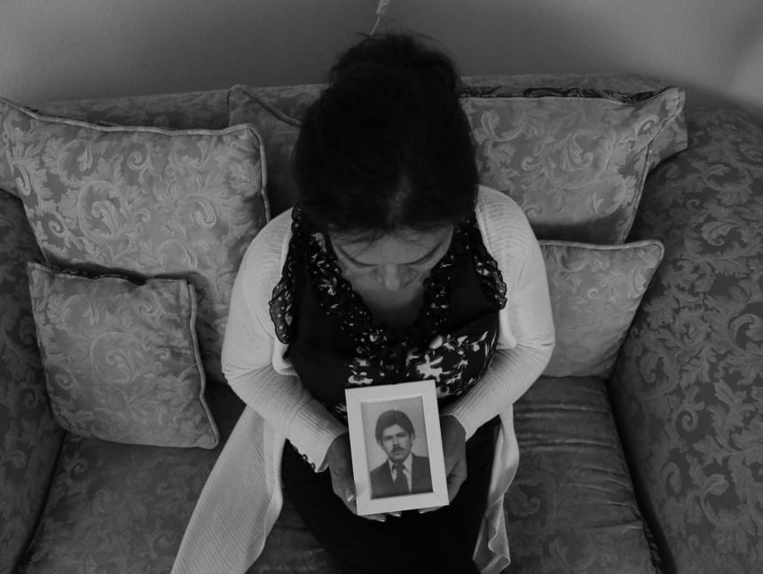 Leonor Gomez holds a portrait of her husband of 40 years, Hugo Rolando Gomez, who was detained by ICE outside their home on August 16, 2019. July 12, 2022. Photo by Zaydee Sanchez for palabra