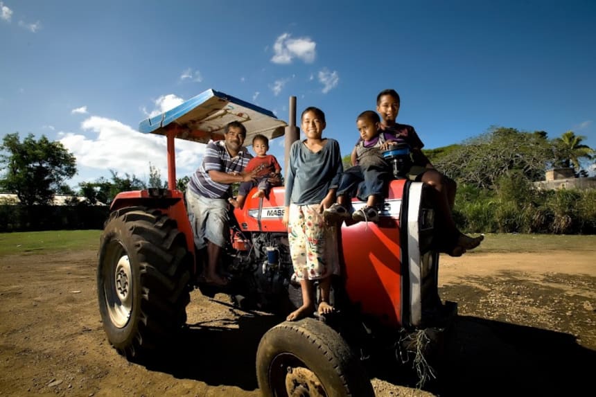Family affair: Sione Vaianginam, a farmer, with his children on their tractor in Nukuʻalofa, the capital of Tonga. (Photo credit: Luis Enrique Ascui/Asian Development Bank/Flickr, CC BY-NC-ND 2.0)