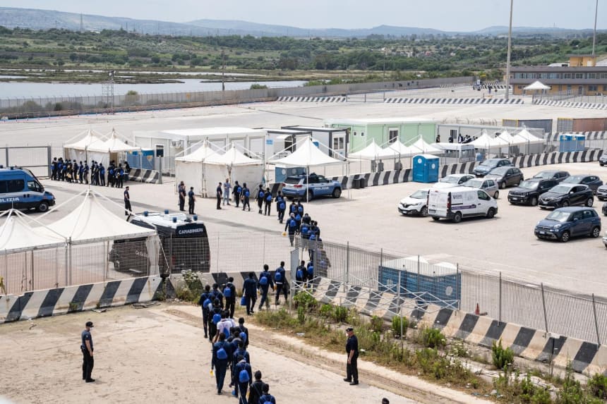 In Augusta, Italy, survivors disembark from the Geo Barents into a waiting area where they are processed by the Italian government. May 19, 2022. Photo by Lexie Harrison-Cripps for palabra