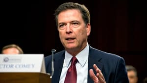 James Comey, the director of the Federal Bureau of Investigation, arrives to testify before the Senate Intelligence Select Committee during an open hearing.
