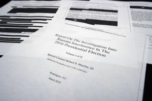 Four pages of the Mueller Report lay on the witness table in the House Intelligence Committee hearing room on Capitol Hill in Washington, D.C. on Thursday. (Cliff Owen / AP)