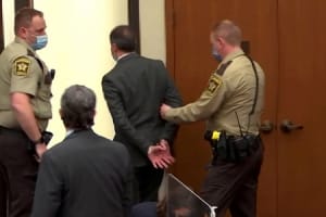 Derek Chauvin in handcuffs while his lawyer, Eric Nelson, watches. Chauvin now remains in a maximum-security prison in Stillwater, Minnesota, until his sentencing is announced in eight weeks.