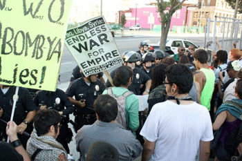 Police block the exit of a parking lot, trapping and detaining about 40 anti-war demonstrators. (Dan Bluemel / LA Activist)