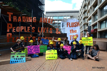 Anti-TPP activists pose after their successful protest drapped the US Trade Representative with four massive banners.