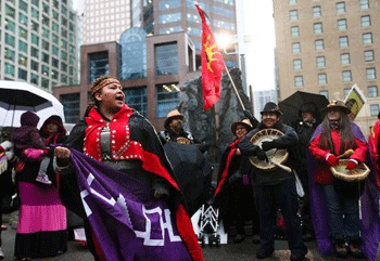 Jerilyn Webster, aka Nuxalk and Six Nations rapper JB the First Lady, speaks at IdleNoMore Vancouver. (Photo: David P. Ball)